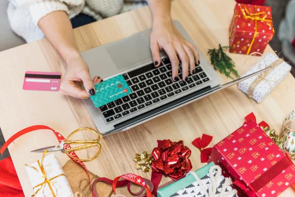 woman using laptop with credit card