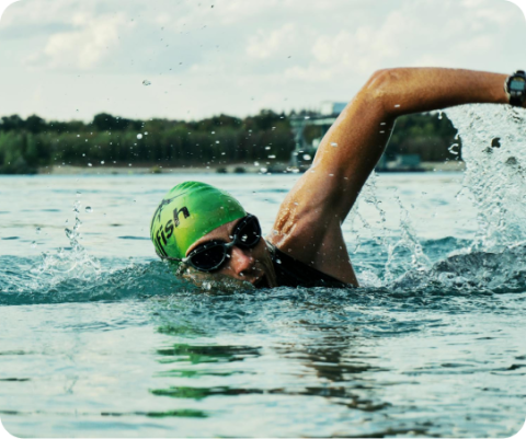 man swims in lake